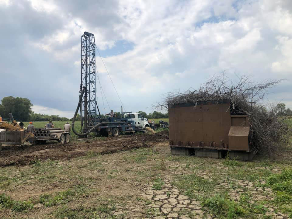 Drill truck drilling in a field.